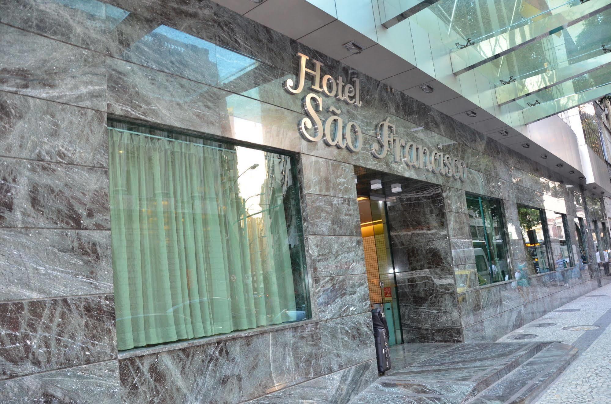 Hotel Atlantico Tower Rio de Janeiro Esterno foto The photo shows the exterior of a hotel named "Hotel São Francisco." The facade is made of marble, giving it an elegant appearance, and large glass windows are visible, likely allowing natural light to enter the interior. There are light green curtai